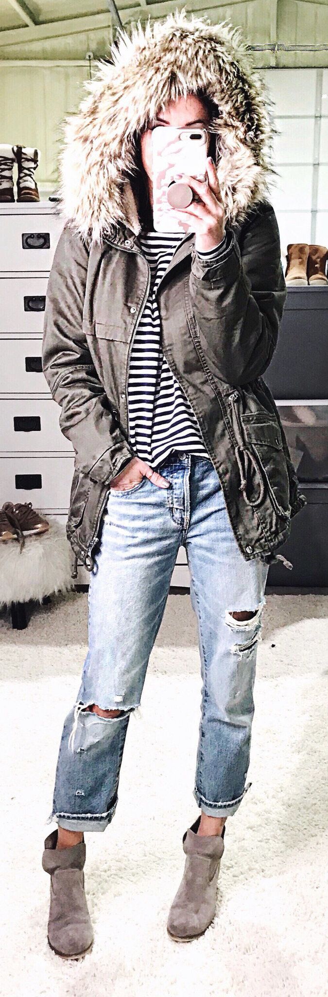 black and brown parka coat and distressed blue denim jeans black and brown parka coat and distressed blue denim jeans