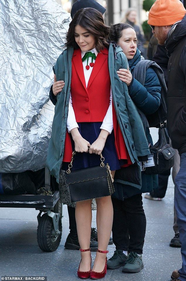 Chilly: While filming, Lucy did her best to keep warm in between takes, adding another coat to her outfit Chilly: While filming, Lucy did her best to keep warm in between takes, adding another coat to her outfit