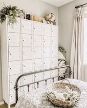 Vintage lockers painted white in a farmhouse cottage guest bedroom in the home. ...