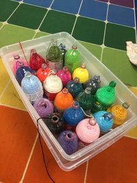 Check out this quick and efficient way for students to cut their own yarn! The trick to getting the yarn in there? Cut open the bottle of the bottle with a blade, insert the yarn skein inside, and tape it back up. | Glitter Meets Glue Designs #yarn #classroomhacks #visualarts