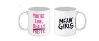 The Mean Girls Logo Mug is a white ceramic mug featuring the title on one side and "You're REALLY pretty." on the other.