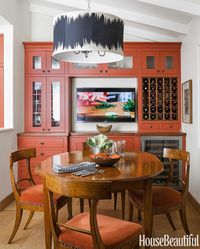 The custom light fixture is almost as large as the breakfast table.
