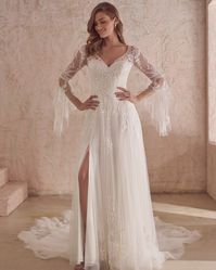 Allow us to introduce you to this ethereal lace A-line wedding gown! From the bell sleeves to the sexy thigh high slit....what is not to love?! Click through for all the deets! #A-lineweddinggown #bellsleevebridaldress #laceweddingdress #Maggiesottero