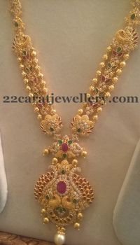 Gold balls and uncut shaped CZ stones, simple rubies and emerald studded triple layers long chain with peacock style classic pendant, ...