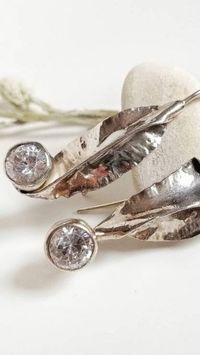 This earrings are very similar to ones that were custom made for a bride. They were the perfect match for a spring wedding. They are so unique that is impossible that every new version will look the same as the pictured ones. If you want this ones, I have one in stock. And if you want a custom made jewel, feel free to contact me!