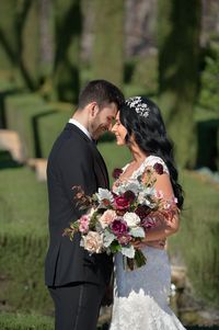 Add a cap-sleeve lace dress and flower crown to your garden theme wedding! #maggiesottero #sotteroandmidgley #mermaidweddingdress #capsleeveweddingdress