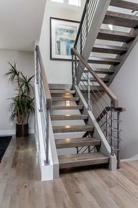 Custom floating stair case with hardwood treads and a metal rail. What a dramatic way to make a statement. Built by Denver Design Build in the LoHi area of the Denver Highlands. www.DenverBuild.com Jay Feaster