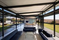 The spacious entertainment wing can subdivide into several individual spaces, separated with full-height glass stackable doors. The ultra-modern structure is complemented by the minimalist lines of the Arnie sofa set from Comfort Creations and glass coffee table from @Home.
