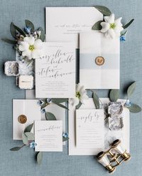 The modern script of our Romantic Calligraphy invitations, paired with the dusty blue belly band and gold wax seal is a gorgeous way to introduce a contemporary wedding! Photo credit: @aprilandmikeraymond
