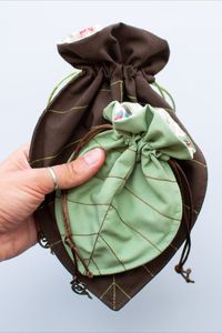 This set of 2 magical drawstring leaf bags made by A Thousand Fairies are inspired by mother nature and a must-have for all nature and forest lovers! They are perfect to keep your essentials together in your purse or around the house. You can store your cherished items, including Tarot cards and crystals. These pouches are a beautiful gift for every girl or woman who loves enchanted forests, ancient trees, woodland fairies, pixies and elves. They have a moon fairy charm at the end of the cord.