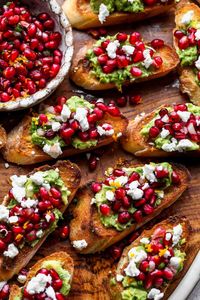 Mini avocado toasts topped with sweet and zesty pomegranate salsa and goat cheese. Simple yet impressive, this is the perfect fall brunch dish or appetizer! #holidayappetizer #easyappetizer #avocadotoast