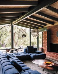 Patricia Urquiola’s Tufty-Time sofa for B&B Italia meets Pebble coffee tables by Nathan Yong for Ligne Roset in the living room.