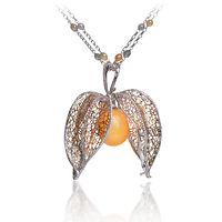 Lugano Diamonds | NATURAL MELO PEARL PENDANT featuring 40 carat Natural Melo Pearl; 5.00 carats of Round Brilliant Collection VS diamonds; 18K White and Yellow Gold setting.