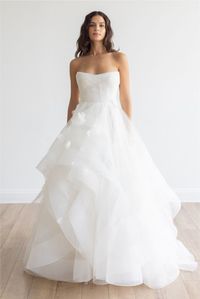 Romantic and boho tulle ballgown with voluminous layered skirt, corset bodice, strapless neckline and 3D floral details throughout. #MissRubyBride Available to try on in store in size 14 Milwaukee, Wi