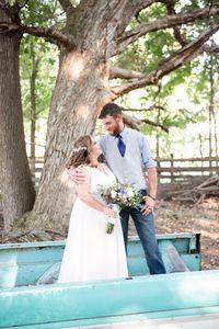 Moon Valley Farm September Wedding in Stafford Virginia | Northern Virginia Wedding Photographer | Emily Marcella Photography | Bride and Groom pose on light blue vintage truck bed after their wedding ceremony during their rustic September farm wedding. Wildflower bouquet, navy blue wedding details, groom jeans and vest, farm wedding, rustic wedding ideas #virginiawedding #fallweddinginspiration #northernvirginiaphotographer