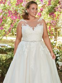 OLIVIA - Rebecca Ingram. A lace bodice and illusion bateau neckline add romance and enchantment to this tulle ballgown. A unique illusion lace back features cascading keyholes, while a Swarovski crystal-embellished belt adds a touch of sparkle. This wedding dress is finished with covered buttons over zipper closure.