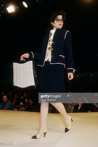 News Photo : A fashion model wears a navy blue haute couture...