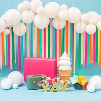 Rainbow Photo Backdrop - A rainbow turns every frown upside down. There is nothing more cheery than this paper honeycomb and streamer photo backdrop. It's impossible to have a less than stellar time celebrating spring with this fun and thoughtful decor. Perfect for photo stations at spring parties for children and adults alike.