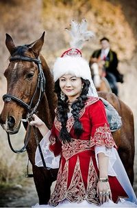 Kazakh woman with horse. More