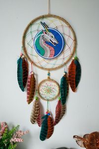 River Spirit Dragon feather dreamcatcher wall hanging bedroom decor anime. Made with attention and love this dream catcher brings its owners good dreams and positive energy. A perfect addition to any room where magic is required to keep bad dreams away or for a bedroom. Measurements: Dreamcatcher ring is 6 inches across.