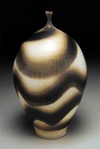 White stoneware, sometimes with porcelain slip for texture. Gas fired in reduction to Cone 10 or approx. 2350 F.