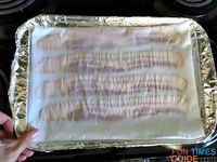 Place the baking sheet with bacon on it into the oven. photo by Candida at TheFunTimesGuide.com