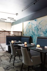 INTERIOR DESIGN BY NOZ DESIGN | In only 4.5 weeks, we tore this restaurant to the studs, and gut-renovated the entire 2-story space that is now fine-dining establishment Avery in San Francisco. We replaced walls with wood screens, inlaid richly patterned carpeting flush with the hardwood, designed a custom ADA-accessible bathroom , and custom-designed tables and banquettes paired with Calligaris chairs, for comfortable luxe seating. Plaster murals by SF artist Victor Reyes
