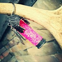 Rustic glittered hot pink shotgun shell keychain with a head dress, arrow and feather.