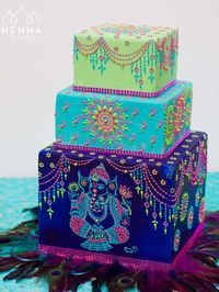 Peacock colors wedding cake by Henna Lounge