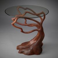 Wood Side Table - Hand carved from laminated cherry wood, this unique table evokes the beauty of trees through the skill and imagination of an artist. Sinuous branches seem to sway in the wind as they spread upward to support a .38 thick glass tabletop. Artfully gnarled roots form a sturdy base that visually anchors the piece.
