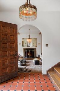 The foyer that welcomes visitors is accentuated by original period tile floors. To the left, there’s a stylish and sophisticated formal living room, whose surrounding windows and overall scale allow light in from every side. The most striking elements in this room are an oversized, original stone wood-burning fireplace and floor-to-ceiling bookshelves that line one of the walls. Take the tour!
