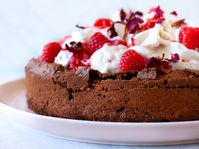 This flourless chocolate cake is sure to woo the special person in your life—even if that's just yourself! Dive into an Anamalai Cacao chocolate cake topped with whipped cream and raspberry rose compote.