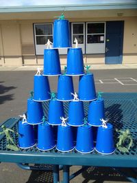 Solo cups and little toy soldiers stacked for Nerf gun target game