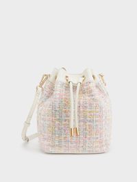 Elevate any look with this elegant light-pink bucket bag. The gold-tone hardware detailing and tweed finish give it a high-fashion vibe while the drawstring closure keeps your items safely tucked away. Bonus points for the bold top handle and additional shoulder strap that offers you multiple ways of wear. Nail your weekend look when you pair it with a floral off-shoulder dress and slide sandals.