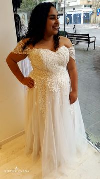 Stunning plus size wedding dress with a princess tulle skirt and off shoulder sleeves. Kerrie. Studio Levana