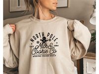 "North Pole Milk Cookie Co Sweatshirt, Baking Sweater, Funny Christmas Shirt, Christmas Gift, Gingerbread Sweatshirt, Milk and Cookie T-shirt HOW TO ORDER: 1-) Please, check and review all photos 2-) Choose your size and color & fill in the personalization field if required. 3-) Click add to cart, you may go back and add more products. 4-) Click \"Proceed to check out\", in the check-out page you can add a note to the seller for any requests. Custom Orders are always welcome, please message us w