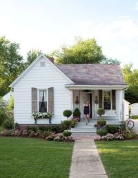 Dreaming of A Little White Farmhouse. Love the extended brick, flower box, and garden