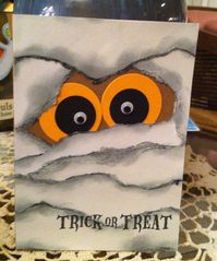 handmade Halloween card ... great version of the mummy eyes card design ... torn and sponged edges on the mummy wrap ... punch art eyes with googly centers ...