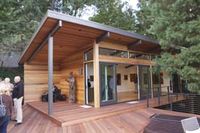 Large wooden deck connects house to outside art studio as well as surrounding trees.