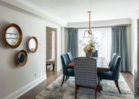 The original floor plan for this renovation project was closed off and divided. The homeowners wanted an open concept layout that would allow for more entertaining space. They also loved colour and trusted us to incorporate some beautiful rich tones and patterns into the palette. A soft white kitchen, waterfall edge island and statement pendant lights helped to balance the space. We paired these design details with luxurious fabrics and natural touches that completed this elegant main floor.
