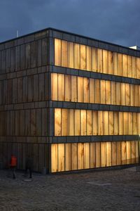 The Folkwang Library at Folkwang University in Germany houses its collection of musicological media in a glass building by architect Max Dudler. The glass, however, is covered with translucent, close-up prints of a stone quarry by photographer Stefan Müller, producing an ambient glow within and without.