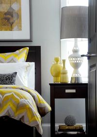 Love the bedding Atmosphere Interior Design Gorgeous gray & yellow contemporary bedroom with gray walls paint color, espresso stained wood bed & nightstand, yellow vases, white lamp and yellow & gray duvet & shams bedding.