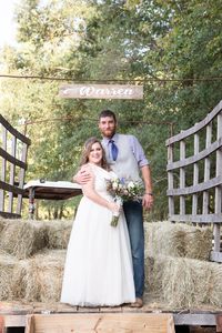 Moon Valley Farm September Wedding in Stafford Virginia | Northern Virginia Wedding Photographer | Emily Marcella Photography | Bride and Groom pose on tractor right after their wedding ceremony during their rustic September farm wedding. #virginiawedding #fallweddinginspiration #northernvirginiaphotographer