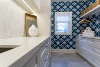 The clients wanted a “sophisticated lodge” feel that could handle their love of entertaining. To achieve this look we sourced natural elements, incorporating wood, stone and hand-scraped details in the finishings. We customized every aspect of their home, down to the smallest detail - custom cabinetry throughout the home, strategic sight lines of their beautiful property, custom window coverings and practical useable space in every room.