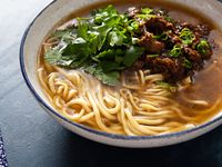 Aromatic lamb soup with a spicy, tingly shredded lamb topping, perfect for serving with hand-pulled noodles.