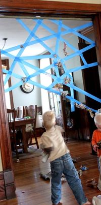 Spider web game. Just use painter's tape to make the web and have the kids throw wads of paper at it to see if they can get it to stick. - would be fun for a superhero party