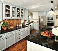 Before & After: A cottage / country style kitchen / Interior Designer: Carla Aston — soapstone counters, island; white and gray cabinet; hardwood floor; lighting, hutch