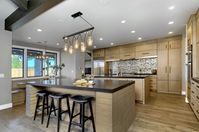 Modern Craftsman style home was built from the bones up. Double Island, Hidden Cookie Kitchen / Pantry with false brick wall, Hidden Hood, La Cantina Doors open completely and seamlessly to allow indoor-outdoor flow. There are fireplaces both indoor and outdoor, as well as firepit/table combo in the outdoor space. #craftsmanstyle #hiddenpantry #pantry #doubleisland #kitchendesign #kitchen #modern #transitional #craftsman #cookiekitchen #indooroutdoor
