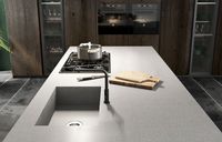 Base cabinets fronts: black steel lacquered oxidized metal effect | Tall cabinets fronts: anthracite aged oak and black aluminum frame smoked glass | Snack table: anthracite aged oak | Worktop: Fenix laminate | Groove and plinth: urban