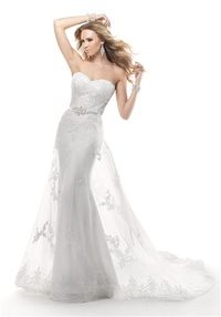 Maggie Sottero Grayson Embroidered sequin lace on illusion tulle over Noveau Satin. Center back beaded motif and attached satin ribbon belt with beaded motif features Swarovski crystals. Silhouette: Sheath Neckline: Sweetheart Waist: Natural Gown Length: Floor Fabric: Lace Embellishments: Embroidery Color: Ivory Size: 0 - 18 Price: $$